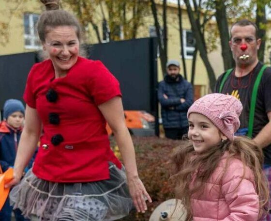 Woman next to kids in a clown shirt