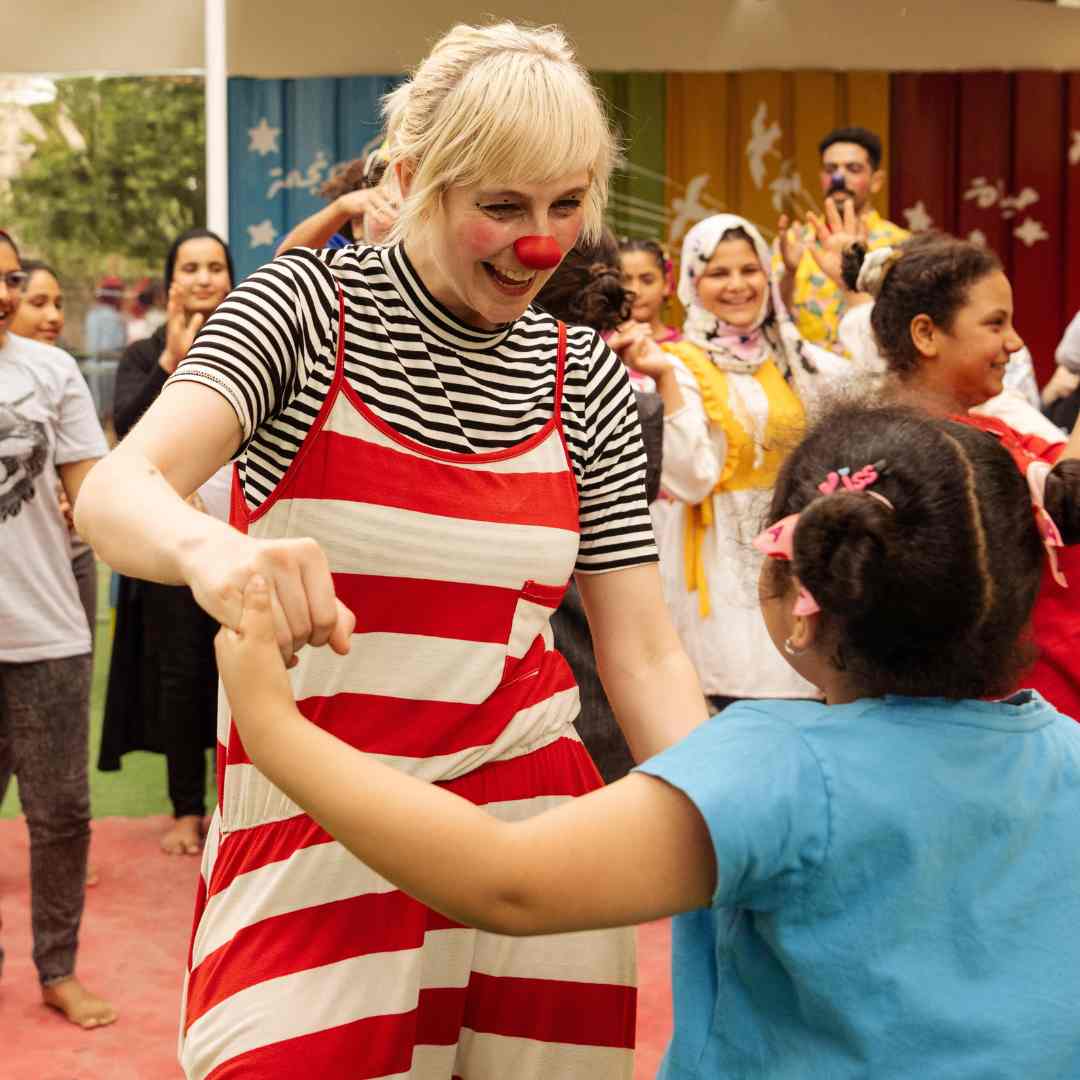 Clown dancing with kid