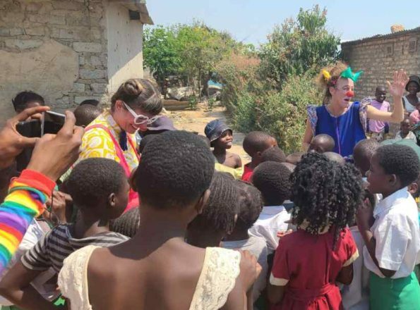 Clowns attending to a group of kids