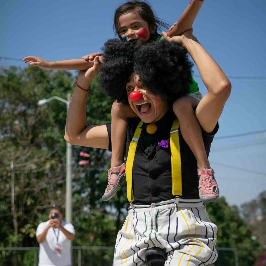 Kid getting piggy back from clown