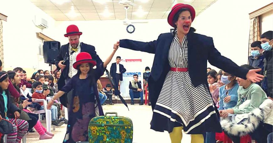 Naomi Shafer with a child, skipping past the audience