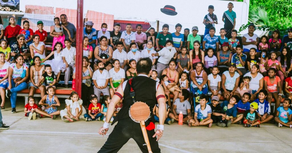 In Acapulco, Mexico, a clown positions himself to catch a hat, thrown by an audience member at a clown show in Acapulco, Mexico.