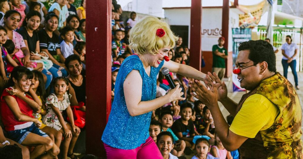 Two clowns dance in the audience.