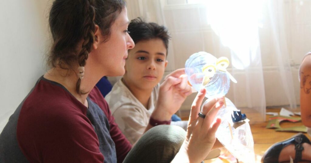 Hannah Gaff with a boy in Egypt making a puppet