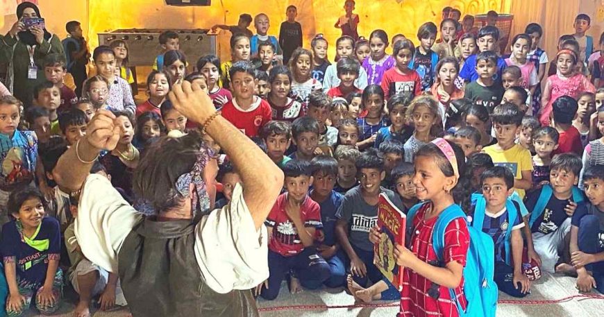 Child presenting a magic book to a clown