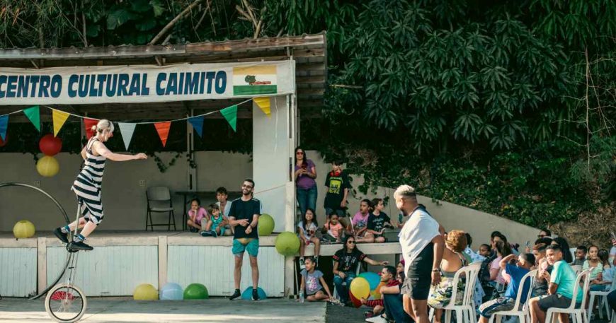 A clown on a unicycle performs for a crowd in Puerto Rico.