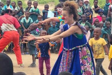 Clowns performing for a group of kids