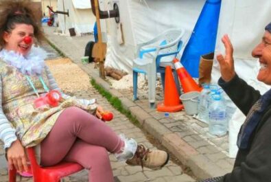 older woman sitting talking with a clown