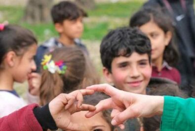 Clown and kid hands touching