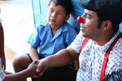 Clown shaking hand of a kid