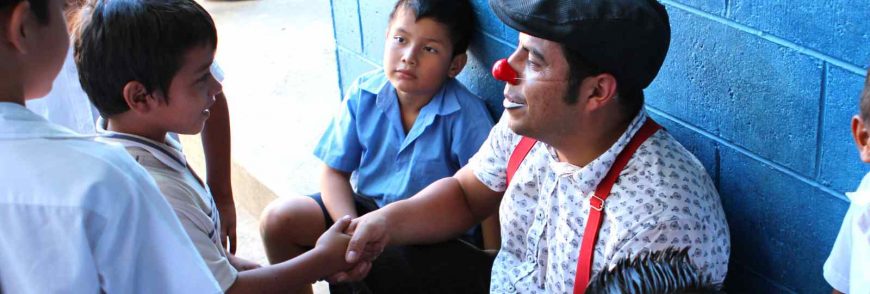 Clown shaking hand of a kid