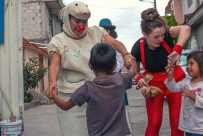 Clowns dancing with kids