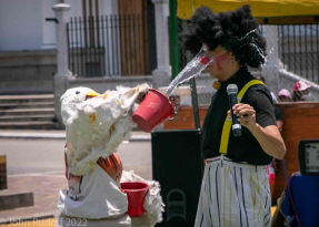 Clown splashing another clown with water