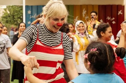 Clown dancing with kid