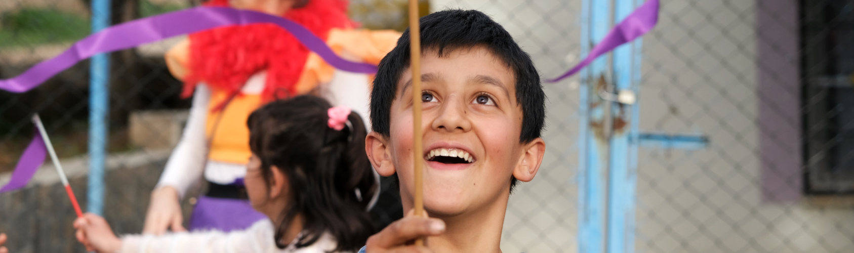 Kid balancing a plate on a stick