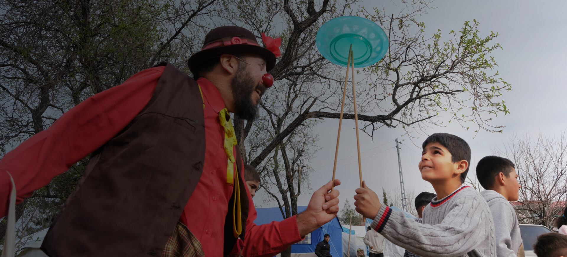 Clown and kid balancing a plate