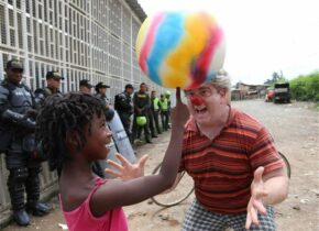 Kid balancing ball on finger