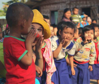 Group of kids and clowns whispering